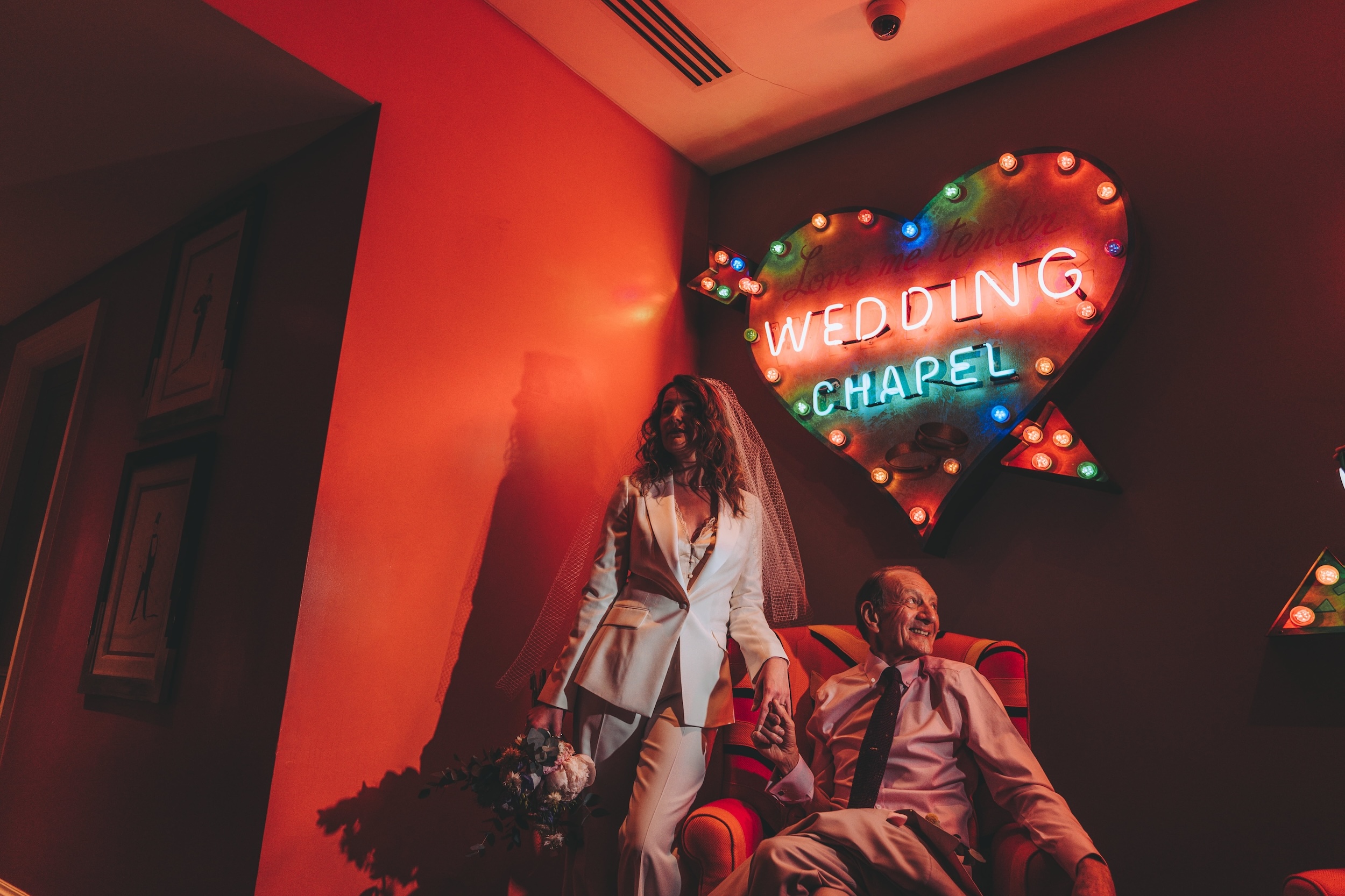 Nicole and Marting under a sign saying Wedding Chapel